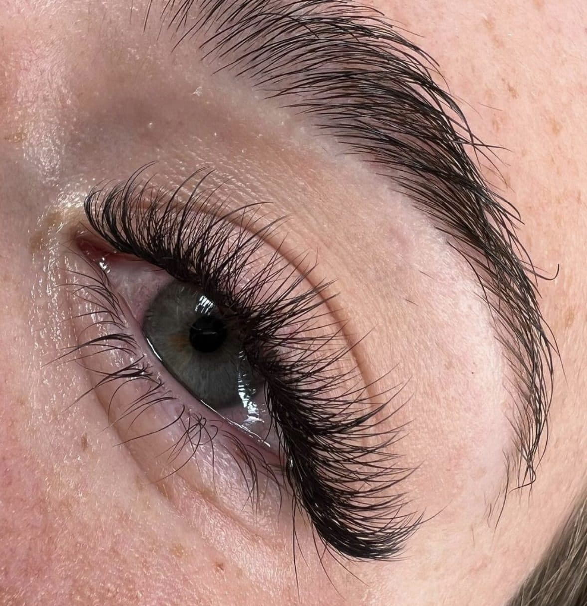 Wispy hybrid lash extensions on a light eye with freckles by 902 Beauty Bar, Dartmouth NS