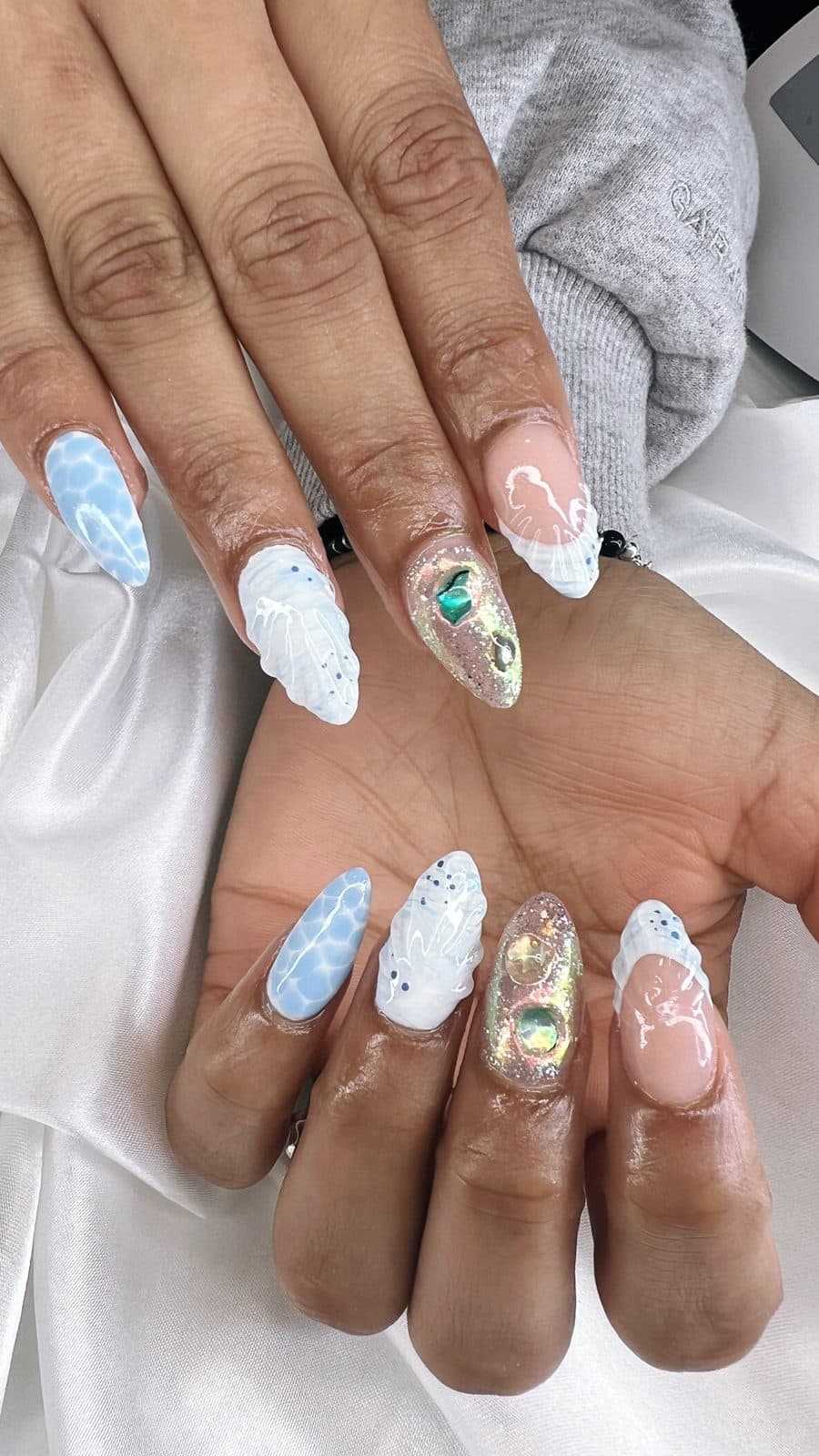 White and baby blue winter nail art with snowflakes and gold accents by 902 Beauty Bar, Dartmouth NS