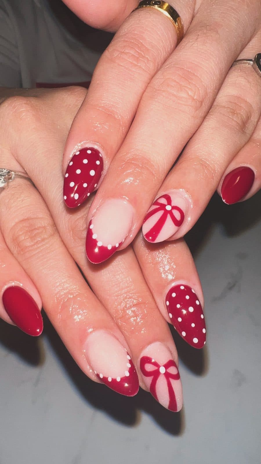 Burgundy nails with white polka dots and hand-painted bows by 902 Beauty Bar, Dartmouth NS