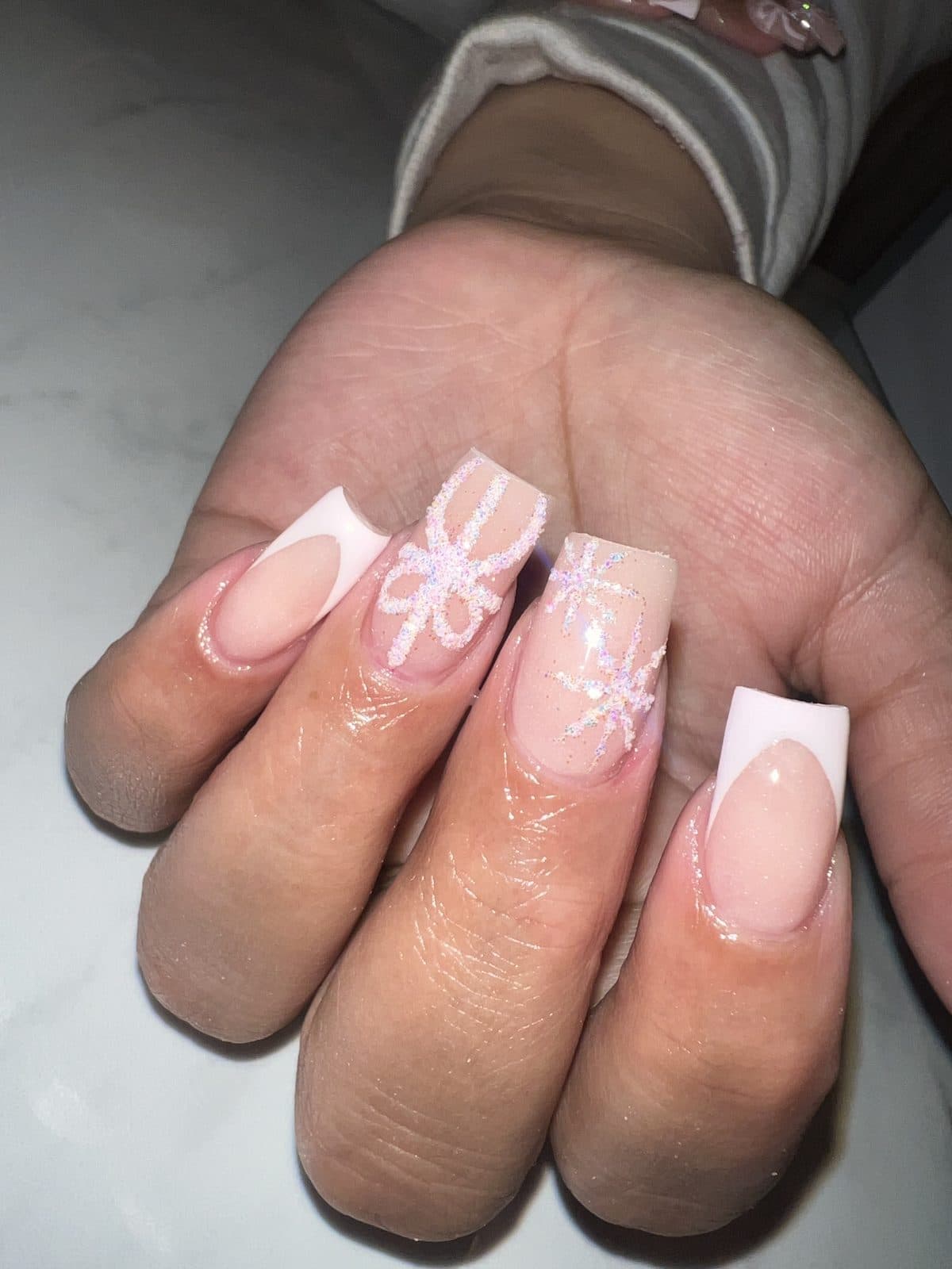 Short square French nails with snowflake and bow art by 902 Beauty Bar, Dartmouth NS