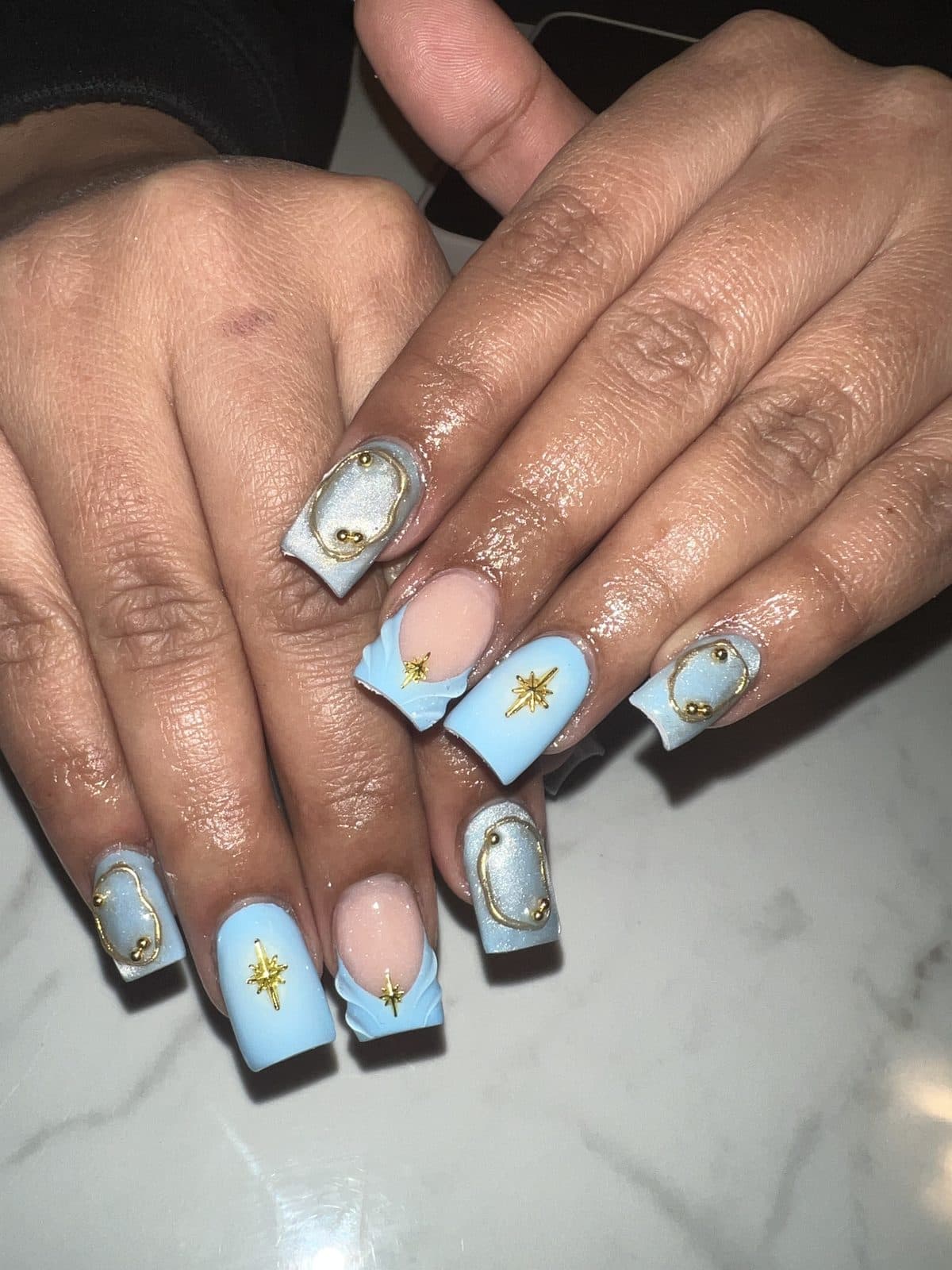 Baby blue nails with gold stars and clouds by 902 Beauty Bar, Dartmouth NS