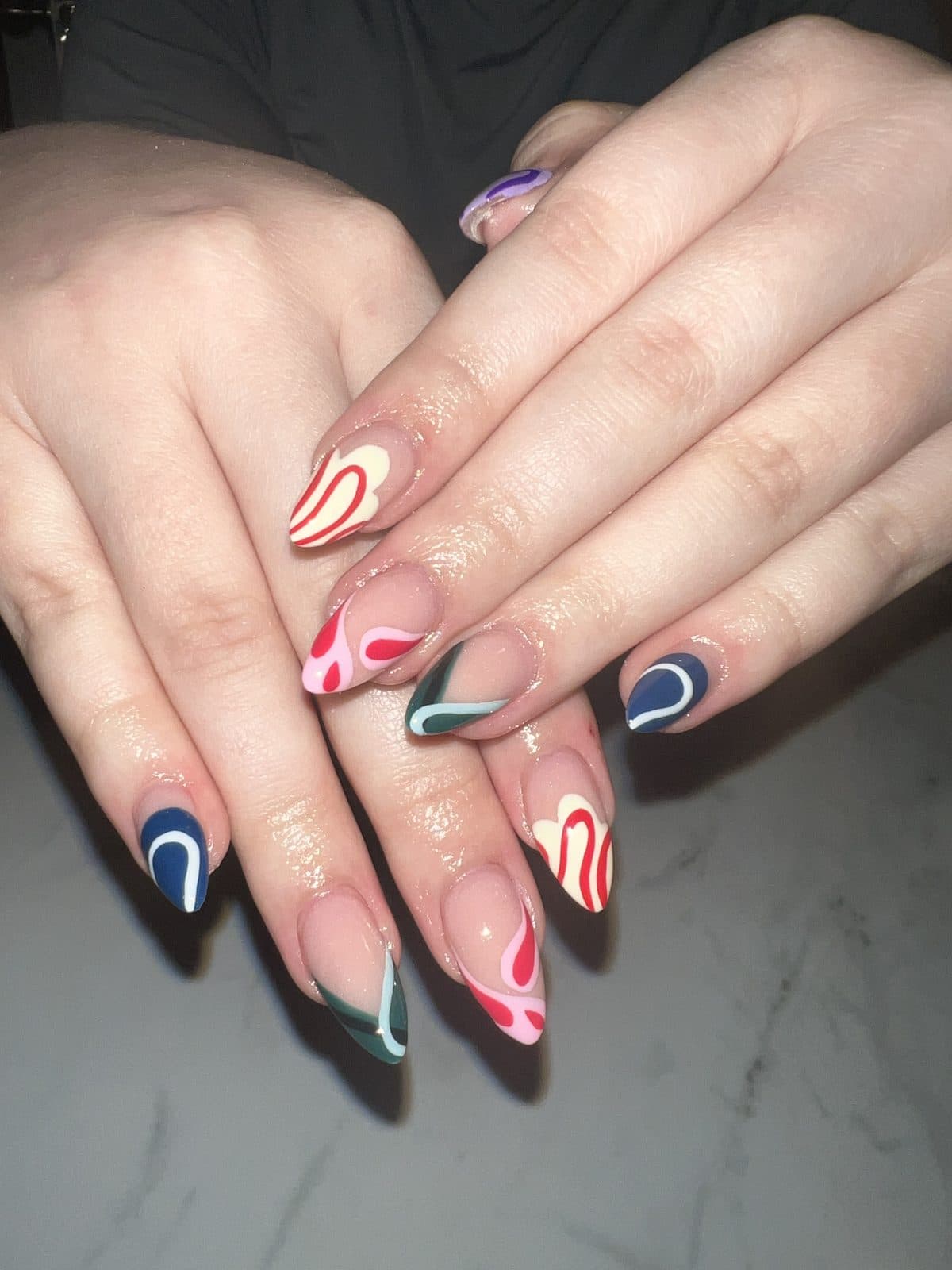 Abstract swirl nail art in red, navy and white by 902 Beauty Bar, Dartmouth NS
