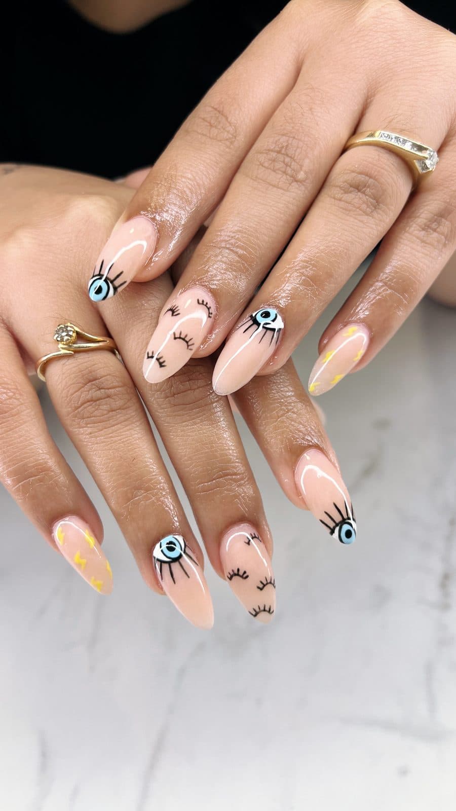 Evil eye and lash inspired nail art on a nude base by 902 Beauty Bar, Dartmouth NS