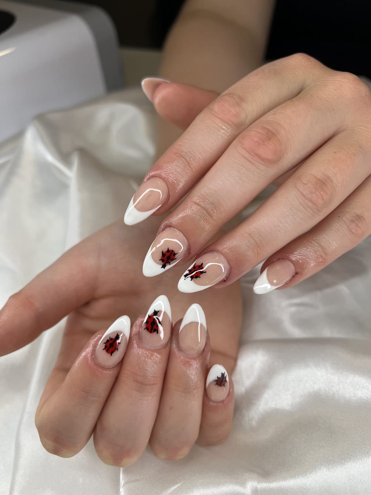 Milky white almond nails with deep red heart accents by 902 Beauty Bar, Dartmouth NS