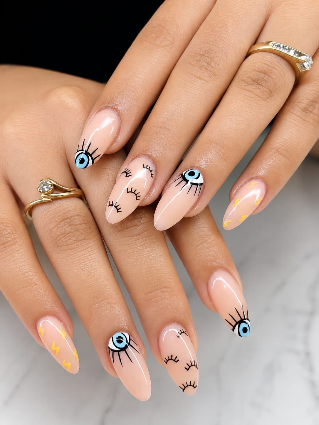 Evil eye nail art with lash details on nude almonds by 902 Beauty Bar, Dartmouth NS