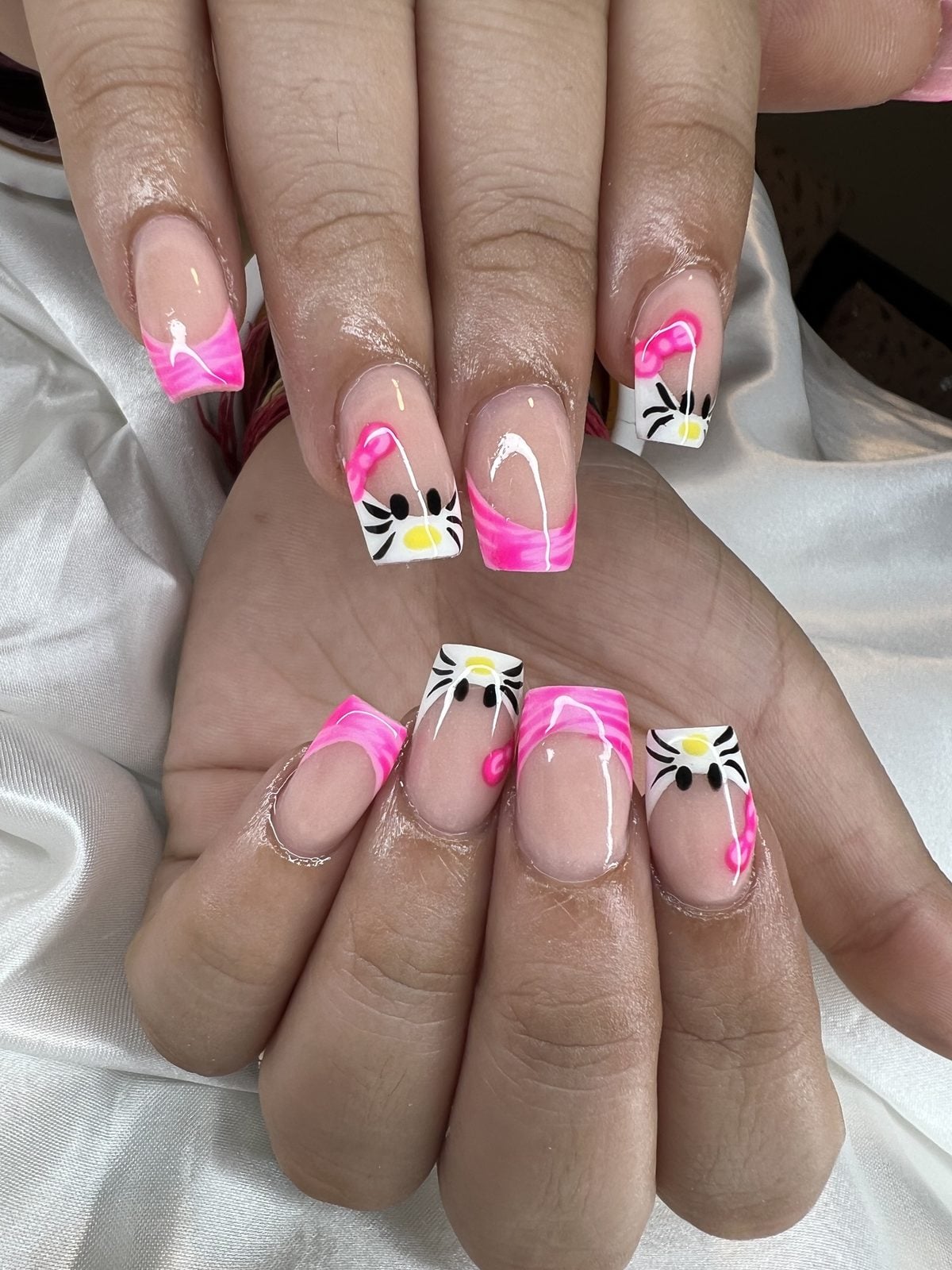 Hot pink French tips with hand-painted flowers and butterflies by 902 Beauty Bar, Dartmouth NS